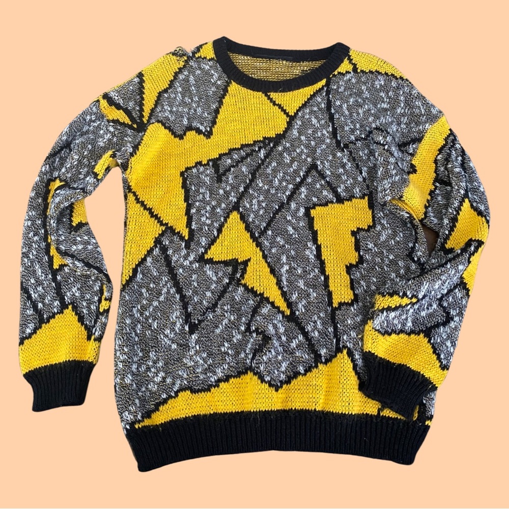 Cozy gray and yellow lightening bolt sweater.  
Best suited for a Small/Medium